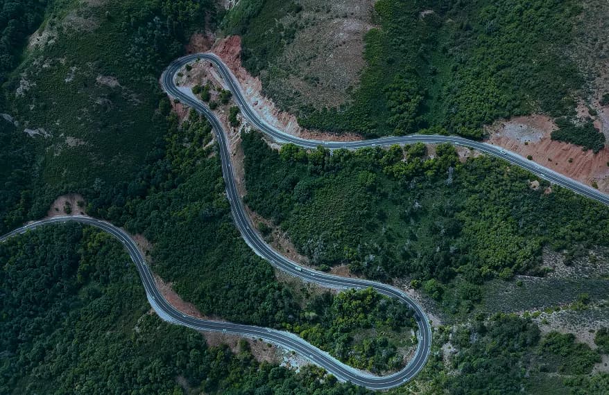 A winding road through green hills